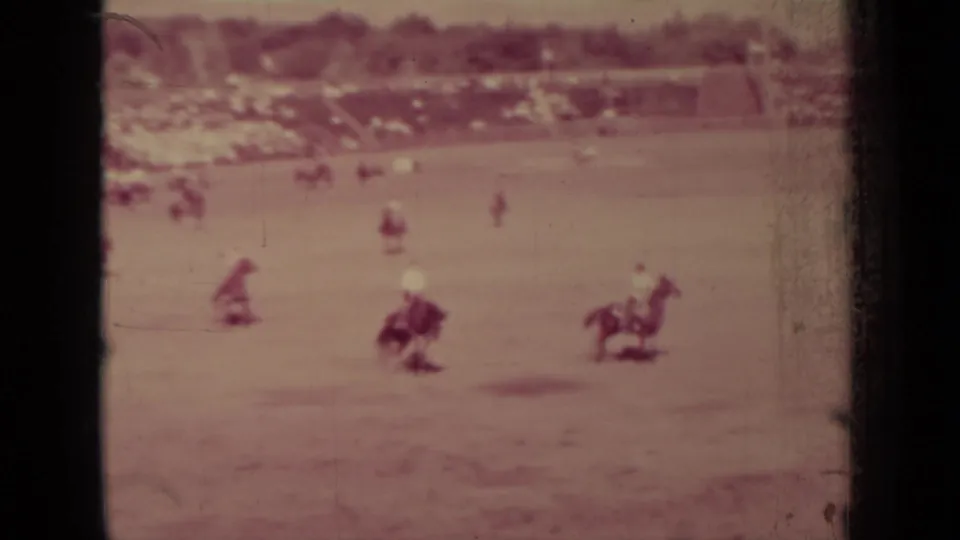 Wide 1937 Klamath rodeo view with riders on horseback dispersed across the arena and a spectator area in the distance.
