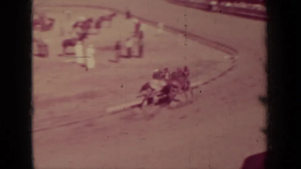 1937 Klamath, California home-movie view of jockeys racing around a curved dirt track before distant spectators.