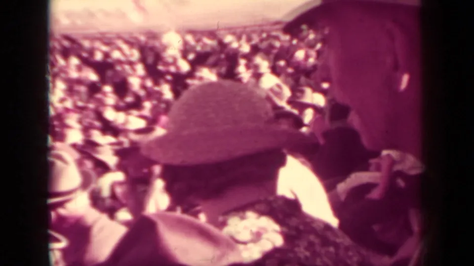 1937 Klamath, California spectator view with hats and faces filling the frame as the race crowd watches from the stands.