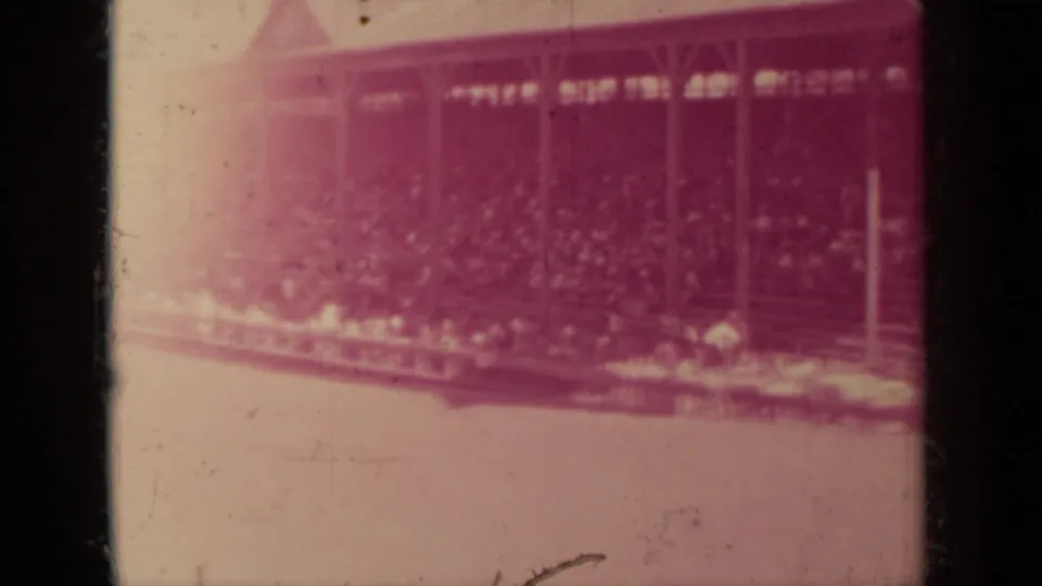 1937 Klamath, California frame with a soft exposed view of spectators seated under a wooden pavilion.