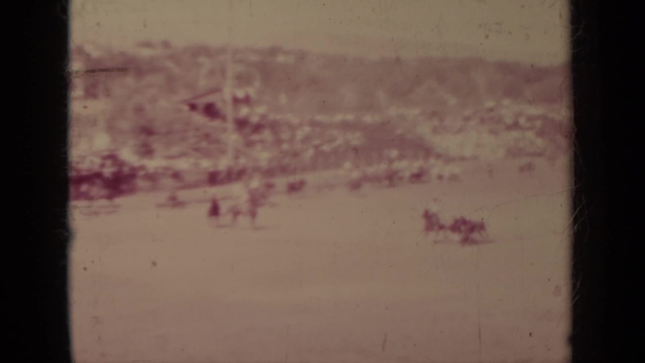 1937 Klamath ranch scene with a distant mounted figure, livestock shapes, open ground, and low buildings in the background.
