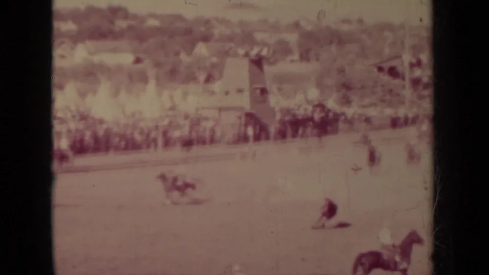 1937 Klamath, California rodeo view showing riders and livestock in a dusty arena with a large crowd behind the fence.