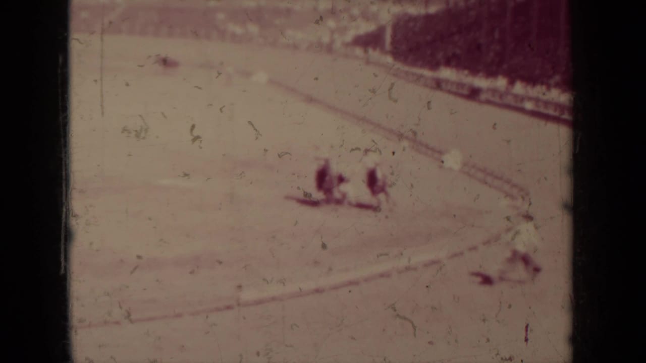 Faded 1937 Klamath home-movie frame showing two horseback riders near the lower edge of a dirt arena.