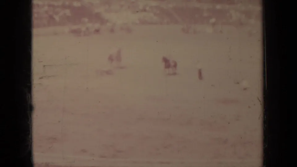 A wide 1937 Klamath field view shows distant mounted figures and horses with spectators blurred along the far edge.