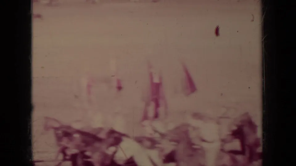 Soft 8mm frame of horseback participants and small flags crossing the dirt arena during the 1937 Klamath ceremony.