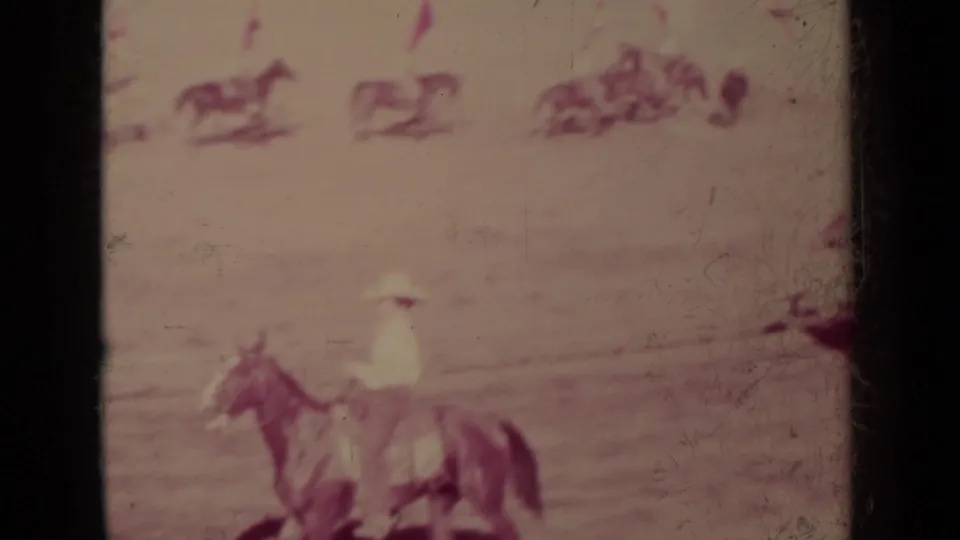 A mounted man in light clothing is seen low in the frame during the 1937 Klamath horseback procession.