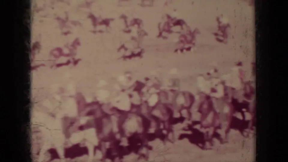 Close home-movie view of multiple riders and horses clustered at a 1937 Klamath outdoor procession or festival event.