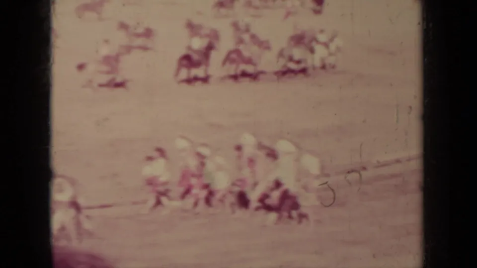 Soft, faded 8mm view of spectators or participants gathered beside the racing area in the Klamath event footage.