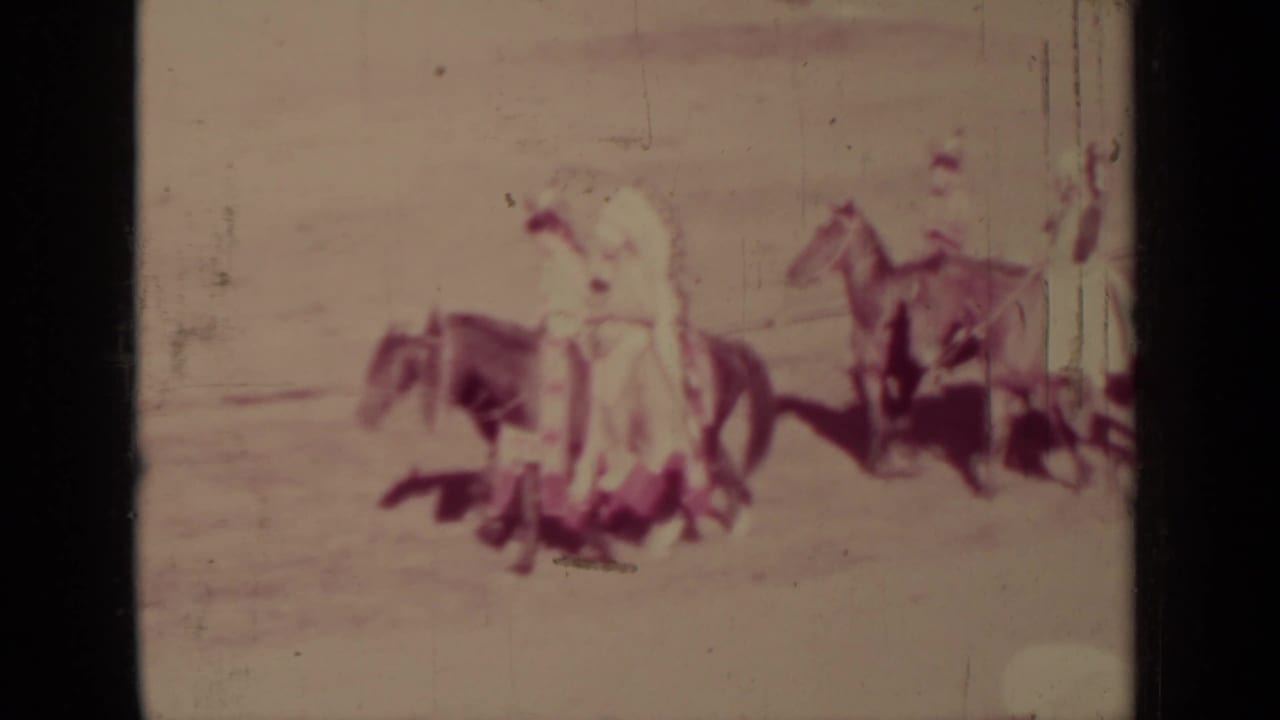 1937 Klamath, California 8mm frame showing several Indigenous parade riders on horseback, seen closer but still soft and faded.