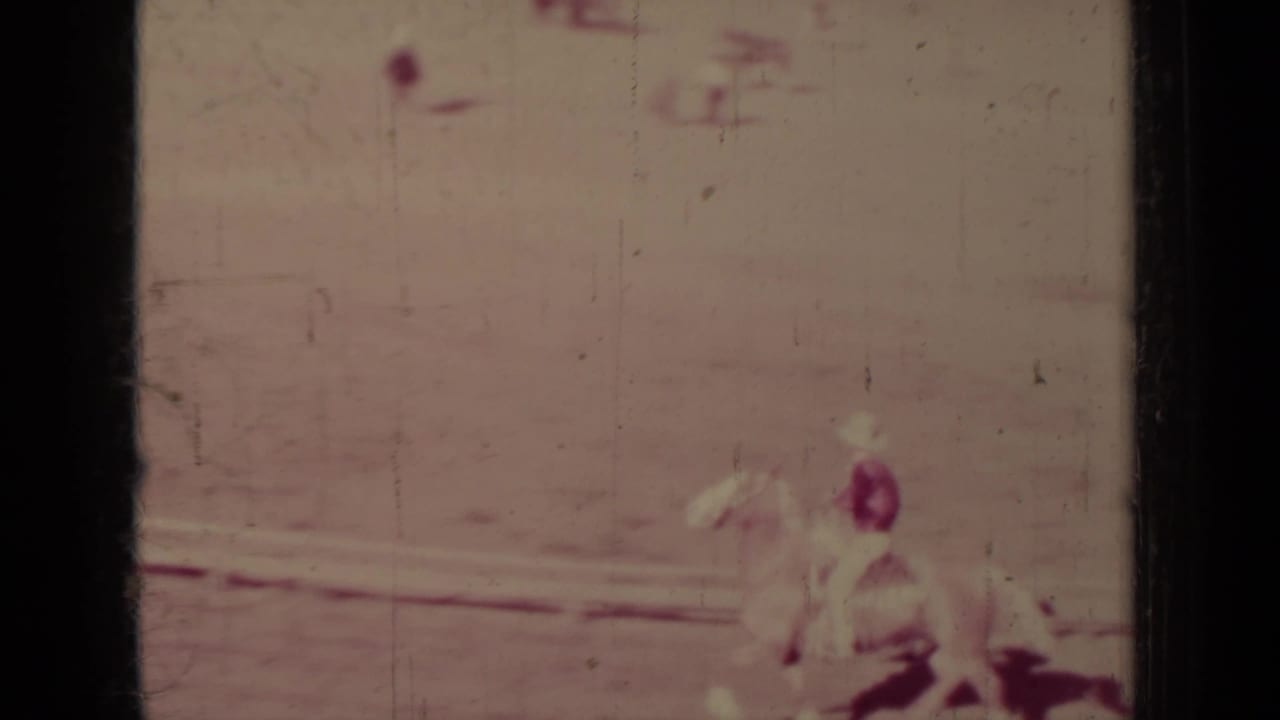 Soft 8mm frame from Klamath, California showing a rider on a light horse moving through the dusty arena.