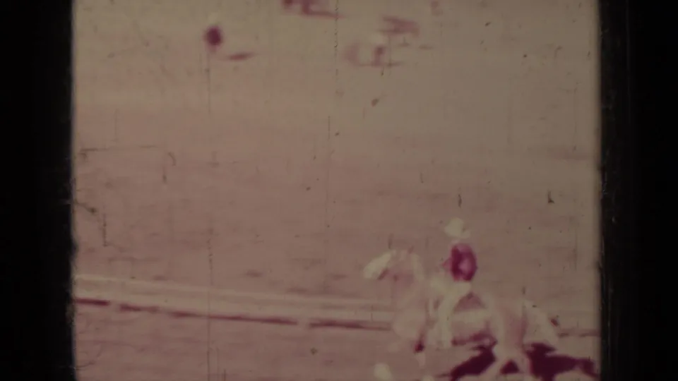 Soft 8mm frame from Klamath, California showing a rider on a light horse moving through the dusty arena.