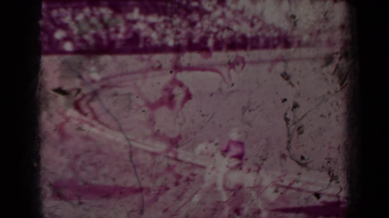 Faded 1937 Klamath-area home-movie frame that may show a rodeo rider or horse in motion, with heavy grain and magenta color shift.
