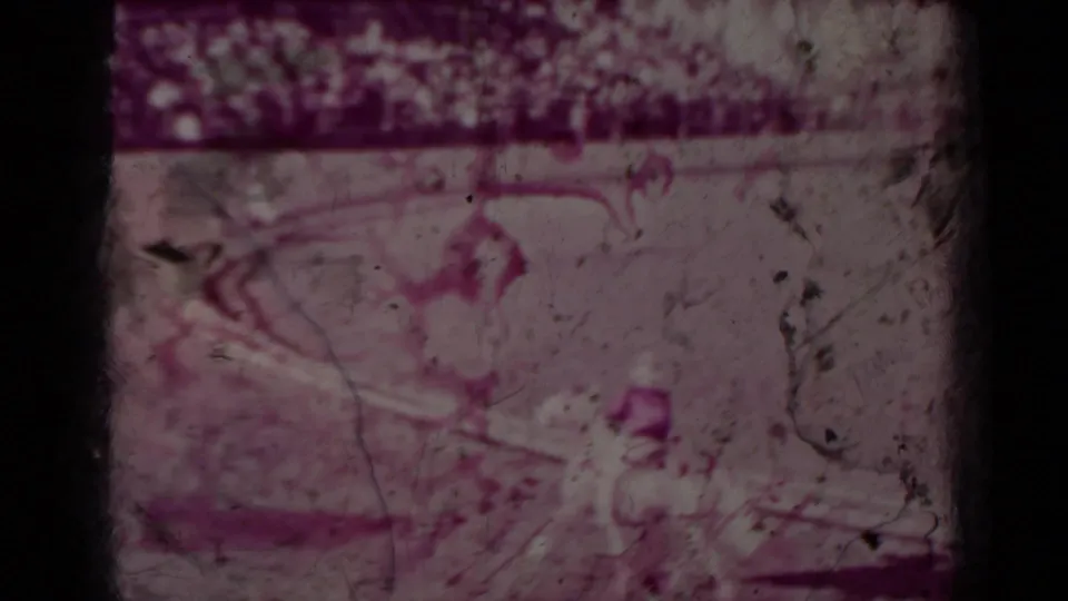 Faded 1937 Klamath-area home-movie frame that may show a rodeo rider or horse in motion, with heavy grain and magenta color shift.
