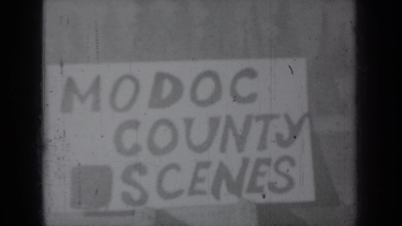 Hand-lettered “MODOC COUNTY SCENES” title card from the 1937 home-movie reel, seen through soft focus and film wear.