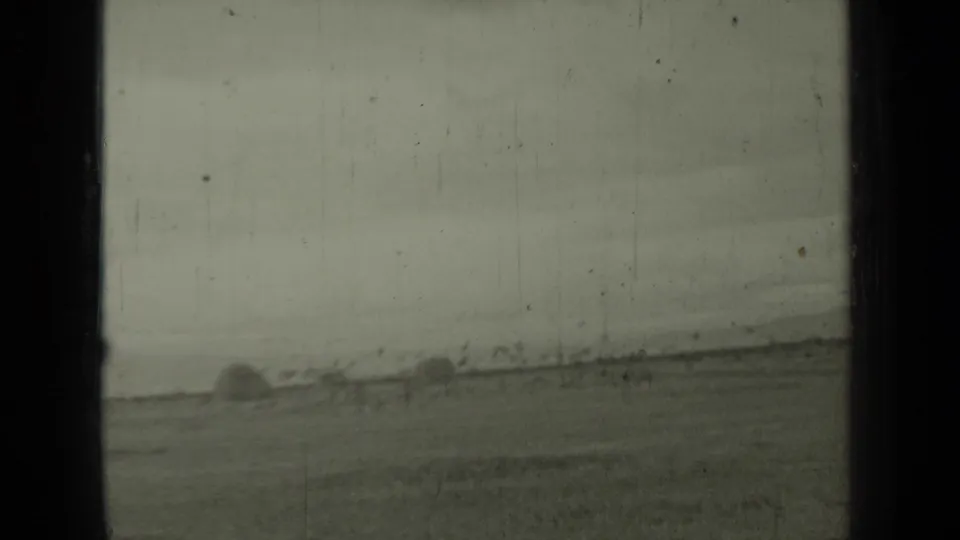 1937 Klamath, California 8mm frame showing a soft, distant field with a hay bale near the edge and visible film aging.