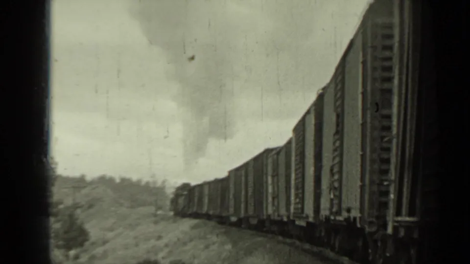 A long Southern Pacific freight train recedes along the tracks in 1937 Klamath, California home-movie footage.