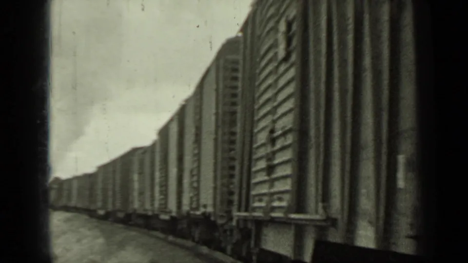 Close side view of freight cars on a curving Southern Pacific train near Klamath, California, captured on 8mm film.