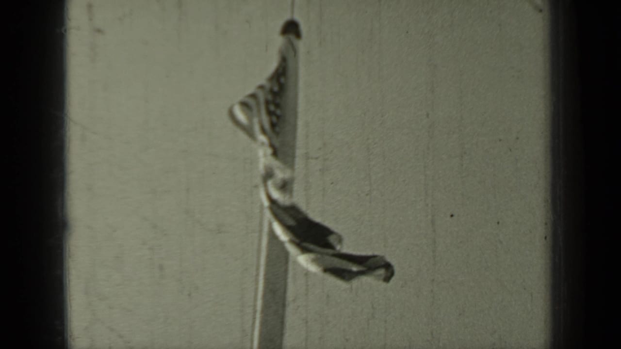 A national flag appears partially unfurled on a tall mast in the 1937 Klamath, California home-movie footage.