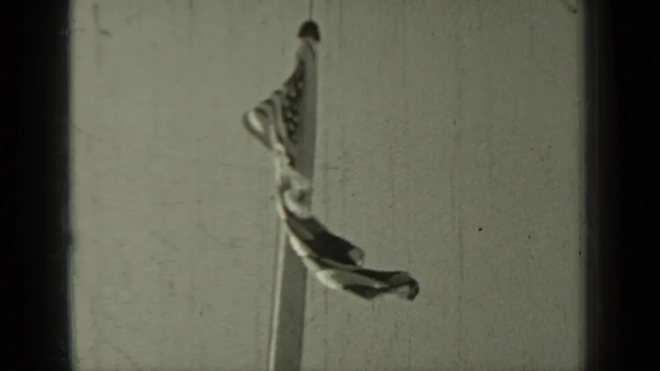A national flag appears partially unfurled on a tall mast in the 1937 Klamath, California home-movie footage.