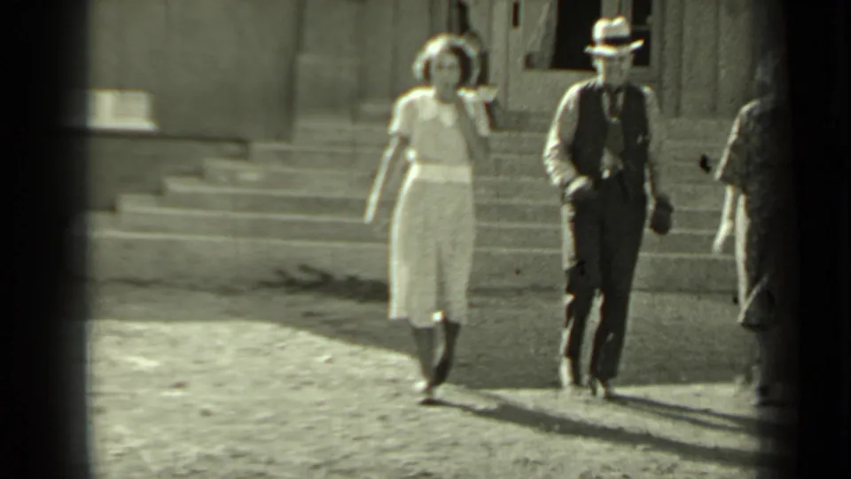 In the 1937 Klamath home-movie frame, the pair approaches the camera as another adult begins to enter from the right edge.