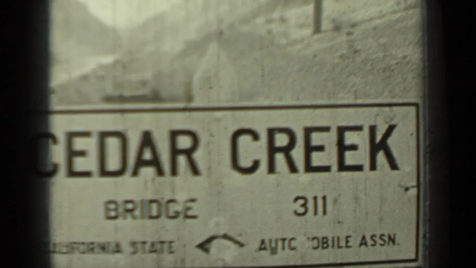 1937 Klamath, California frame showing a Cedar Creek Bridge 311 sign with partial California State Automobile Association text.