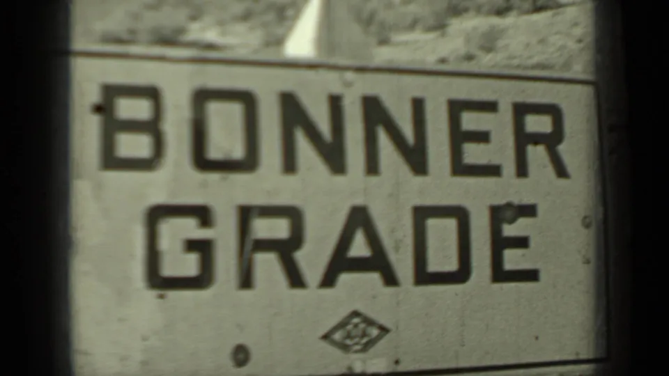 Cropped 1937 Klamath, California view of the Bonner Grade sign, with large block lettering and small emblem visible.