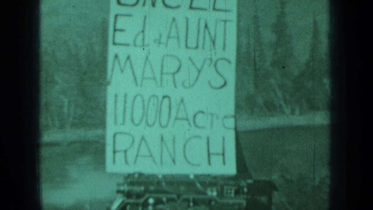 Hand-lettered sign for Uncle Ed and Aunt Mary's 11,000 acre ranch with cars below.