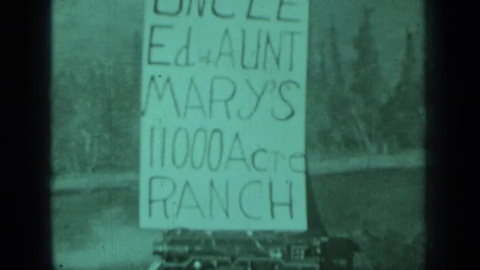 1937 Medford, Oregon frame with the ranch sign repeated in soft focus, showing trees and cars beneath the lettering.