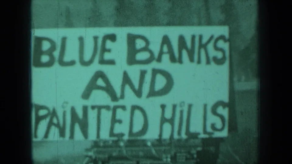 The Blue Banks and Painted Hills sign fills the frame, with large lettering and visible aged 8mm color shift.