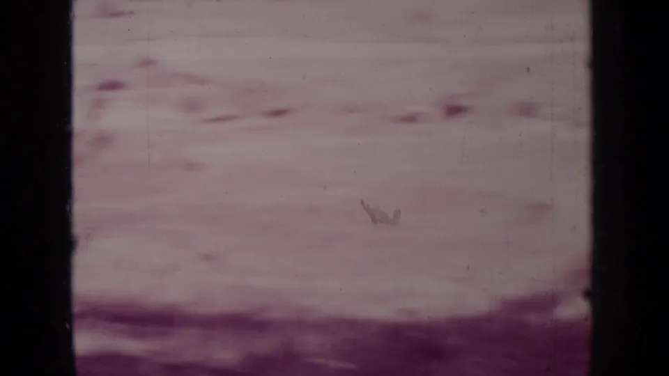 Obscured 1937 8mm frame from the Medford, Oregon clip with pale dry ground and visible film wear.