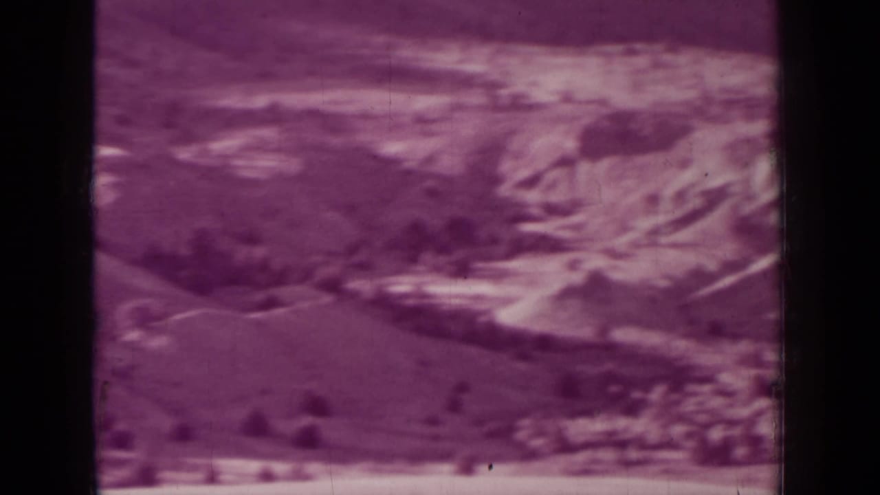 Rugged slopes and light-toned cliffs across a dry landscape.