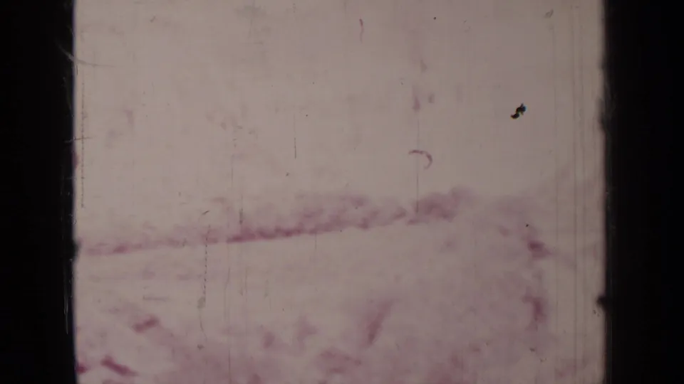 Final 1937 8mm frame near Medford, Oregon, showing a mostly blank, scratched film strip with faint reddish landscape or emulsion marks.