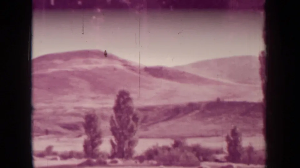 A landscape view shows rolling hills and scattered trees near Medford, Oregon, consistent with the clip's rural-edge setting.