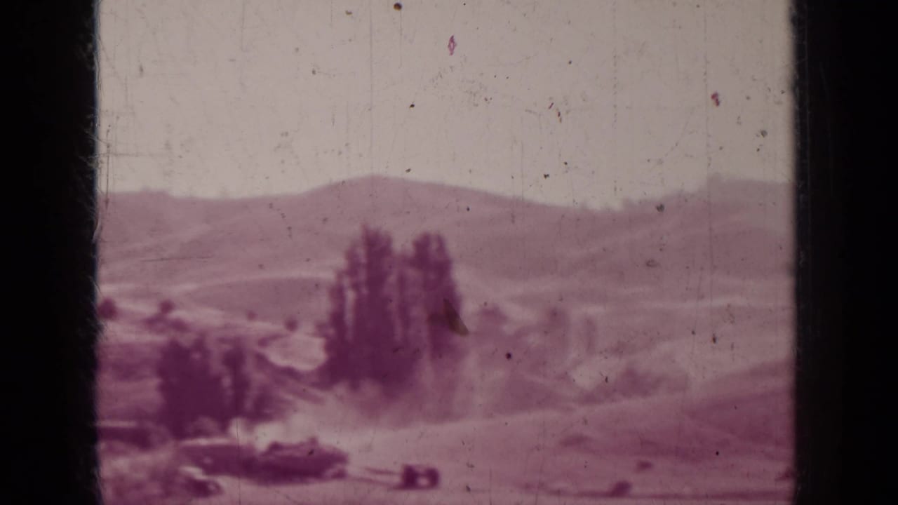 Faded 8mm frame of a rural Medford, Oregon landscape with trees, low hills, and visible film wear.