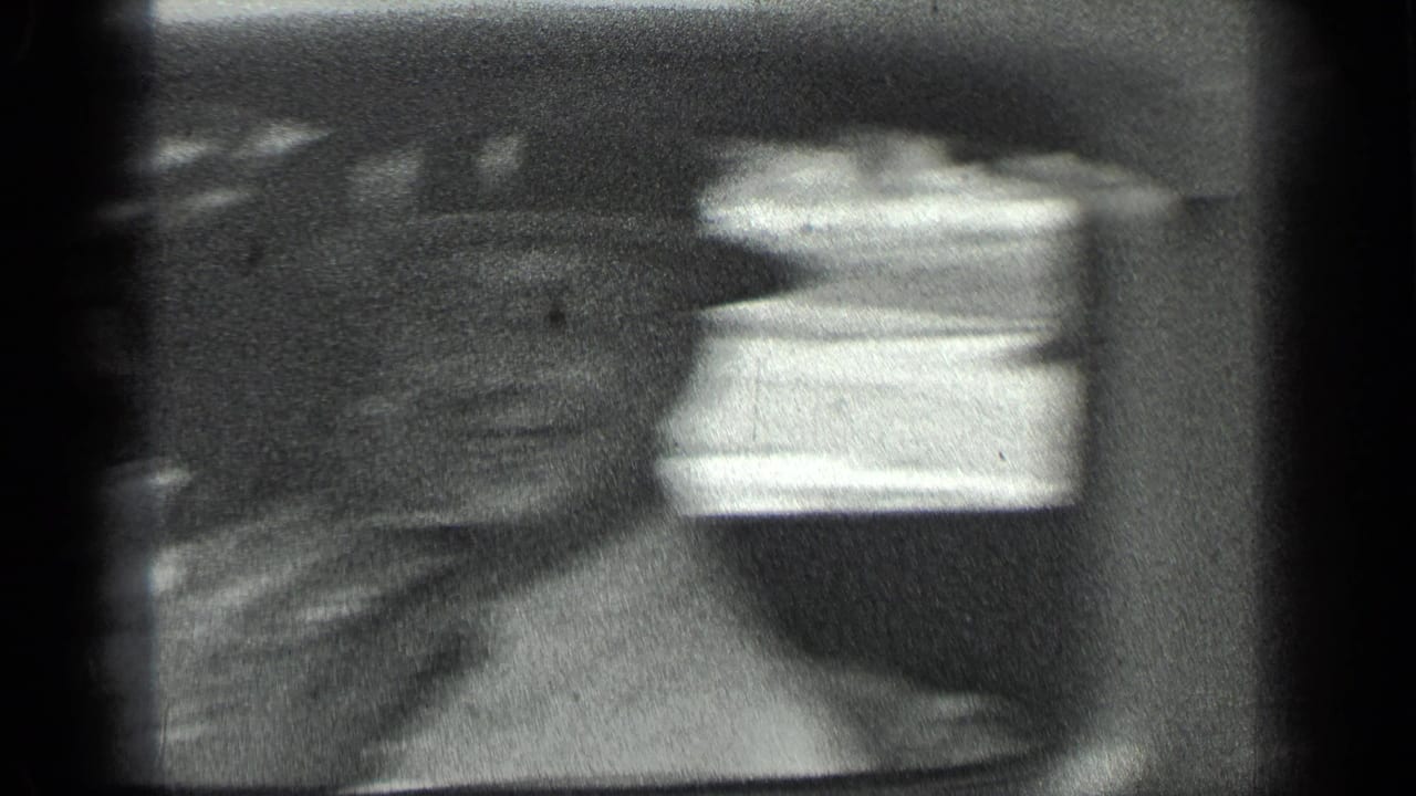 Blurred view of passengers and a bright car window during camera movement.