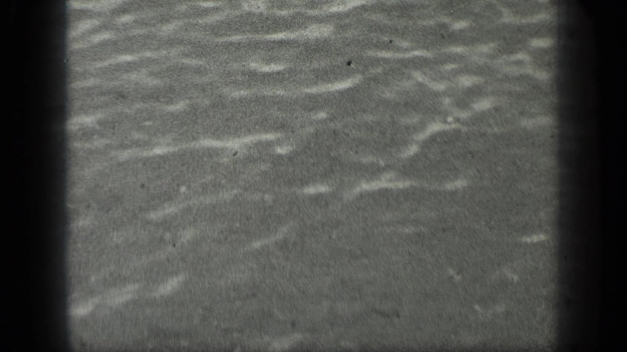 Close view of gently rippling water at Long Lake, Canada, from 1939 8mm home-movie footage.