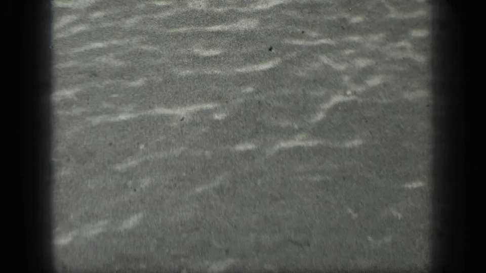Close view of gently rippling water at Long Lake, Canada, from 1939 8mm home-movie footage.