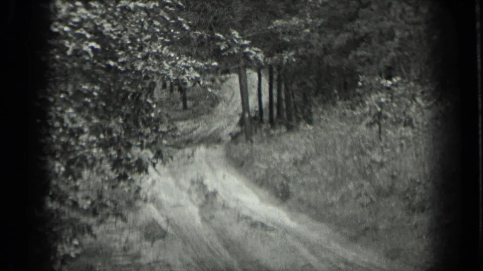 1939 Long Lake, Canada home-movie frame showing a soft-focus wooded track bordered by trees and tall grass.