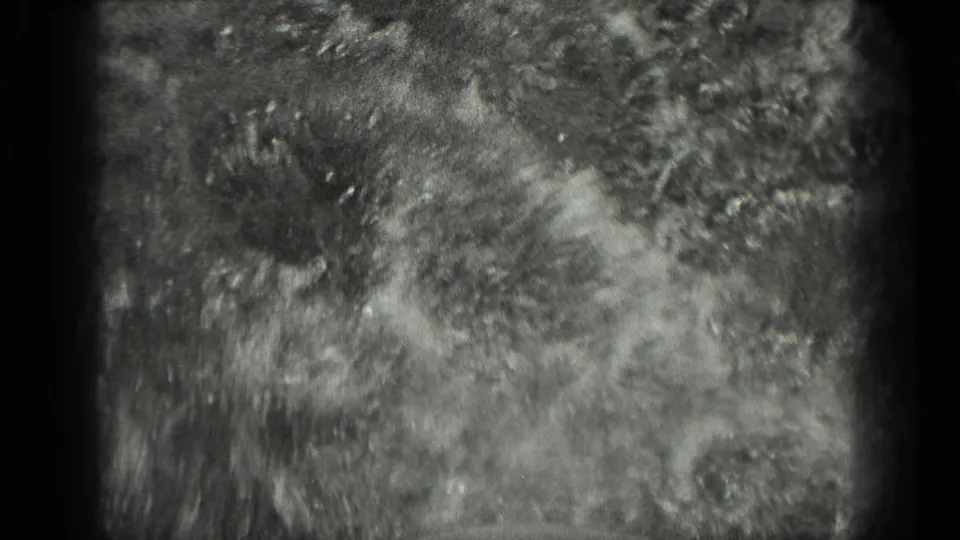 Close 1939 Long Lake, Canada frame showing churning water or wake texture, with grain and exposure variation from the 8mm film scan.