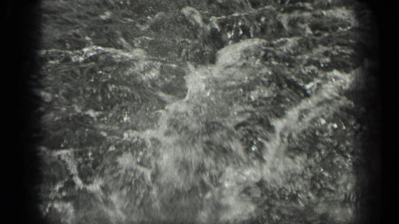 Grainy 1939 Long Lake water detail, with bright ripples and abstract motion filling most of the 8mm frame.