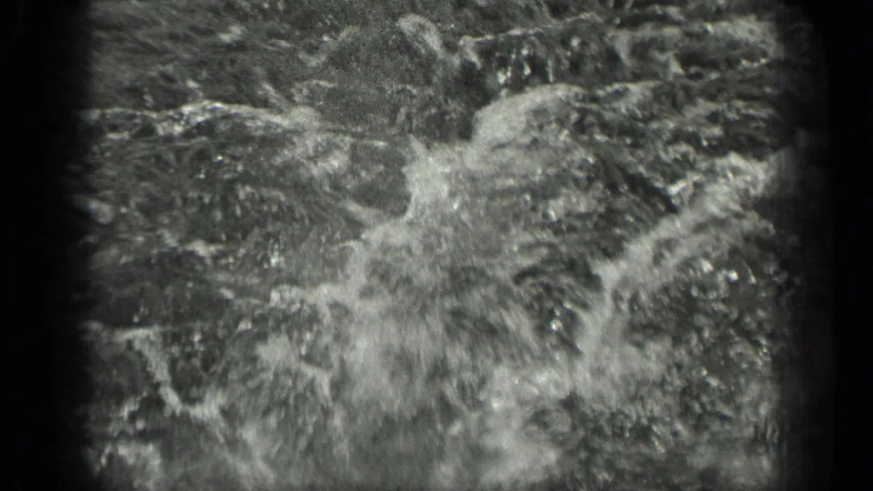 Grainy 1939 Long Lake water detail, with bright ripples and abstract motion filling most of the 8mm frame.