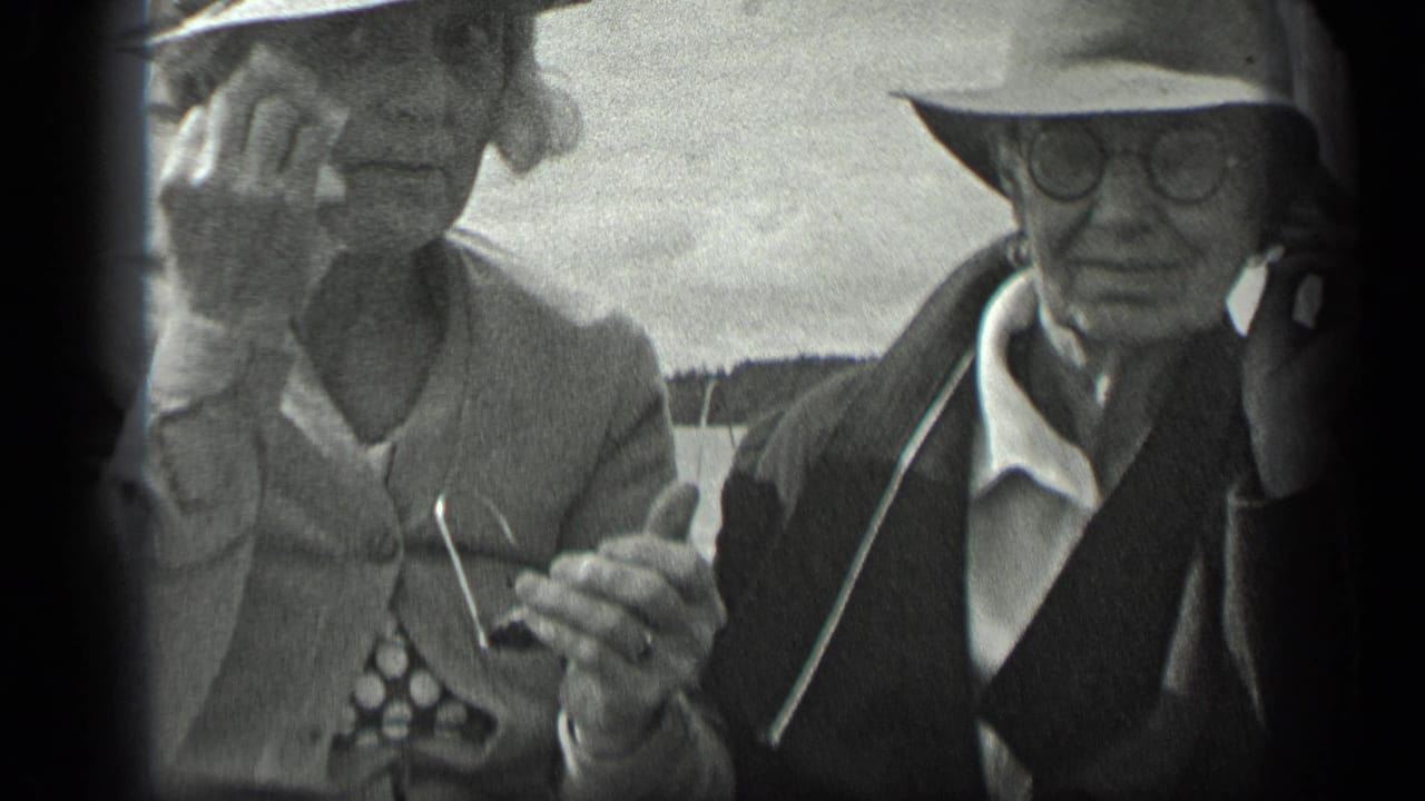 A woman adjusts her glasses while a man in a hat sits beside her on a boat.