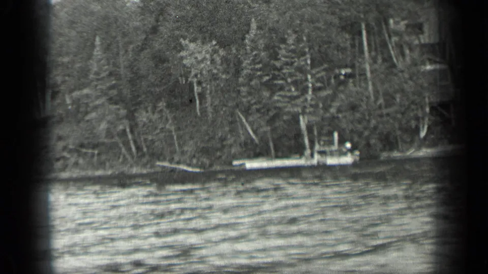1939 Long Lake, Canada footage showing a small boat near a forested shore with rippled water and heavy 8mm frame borders.