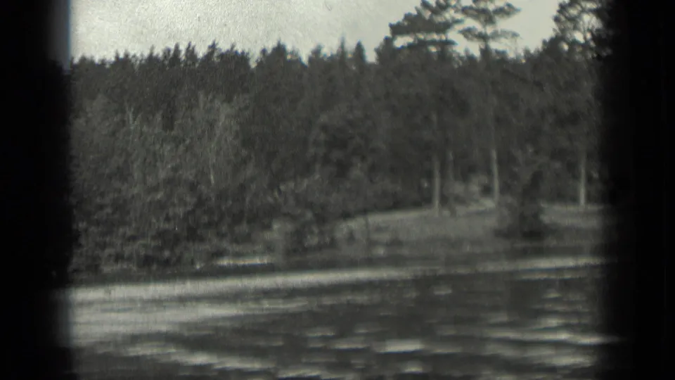Black-and-white 1939 8mm view of Long Lake, Canada, showing rippling water and a tree-lined shore.