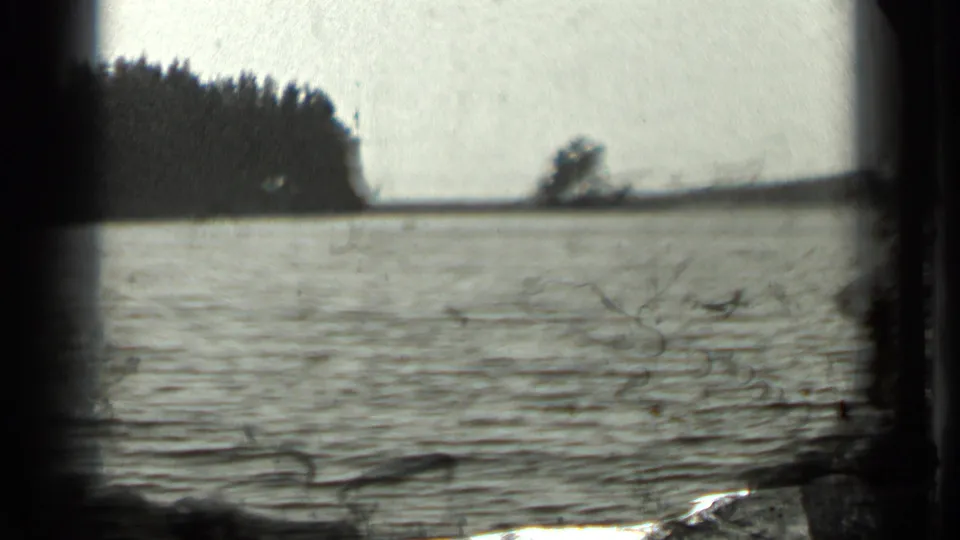 Long Lake, Canada, in 1939 home-movie footage, with soft ripples, wooded shore, and a bright open sky.