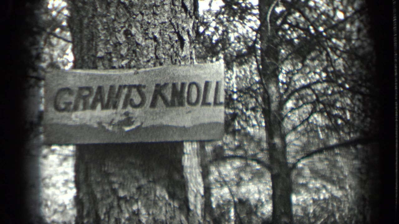 Wooden sign reading GRANTS KNOLL attached to a tree.