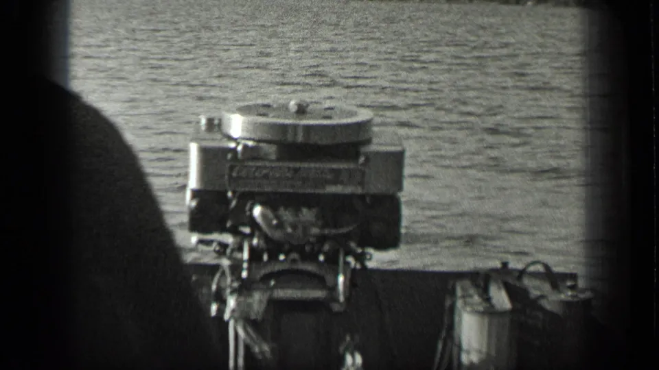 Close passenger-view frame of an outboard motor on a small boat during a 1939 Long Lake, Canada outing.