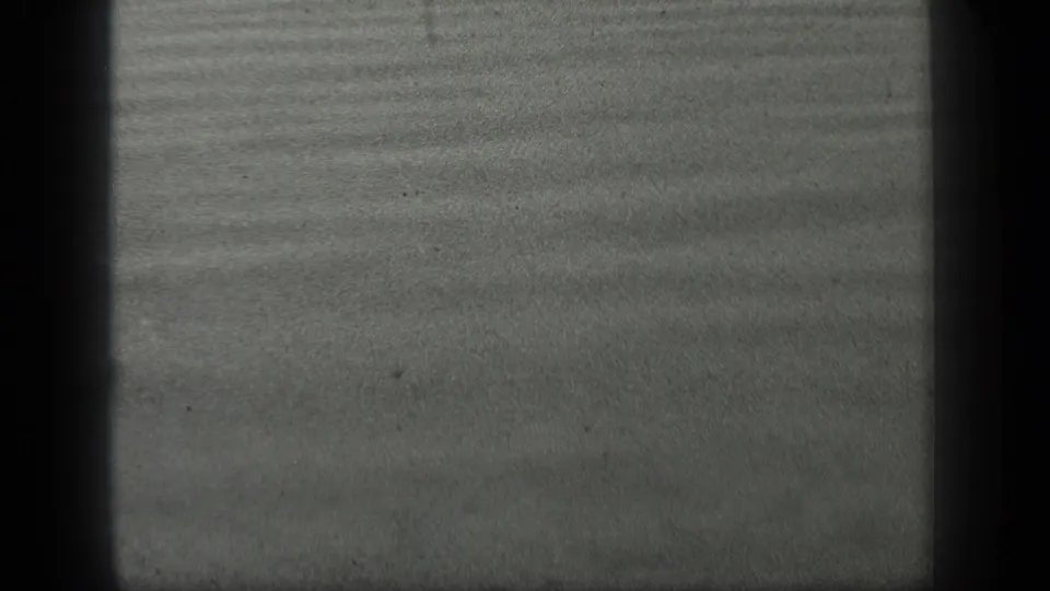 1939 Long Lake, Canada 8mm frame of smooth grey water marked by subtle horizontal ripples and dark frame-edge shadowing.