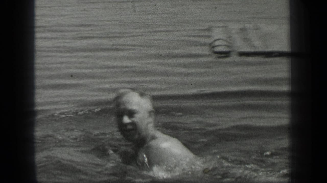 Older man swims near the camera at Long Lake, Canada, in metadata-supported 1939 home-movie footage.