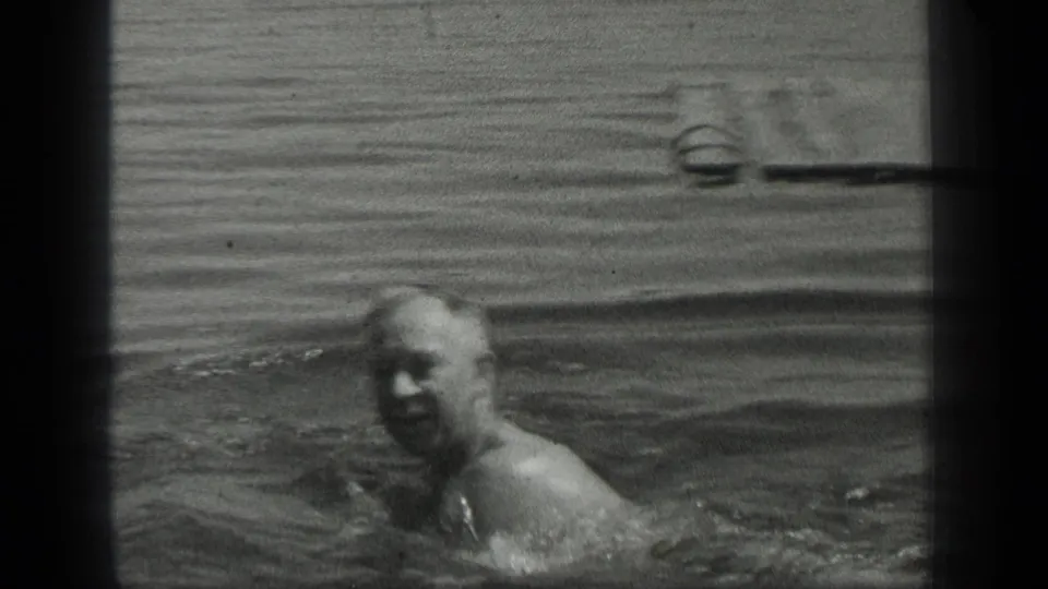 Older man swims near the camera at Long Lake, Canada, in metadata-supported 1939 home-movie footage.